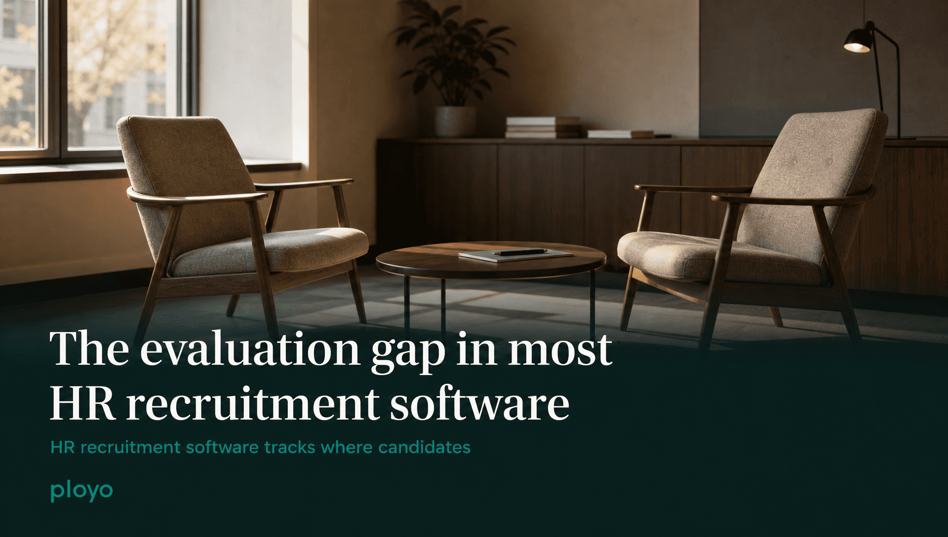 An empty interview room, two chairs and one table, nobody in it, late afternoon light across the floor